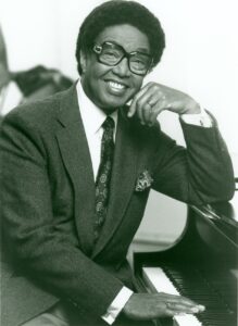 Black and white photo of Dr. Billy Taylor at the piano.