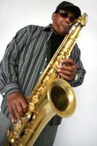 Color photo of Odean Pope playing the saxophone.