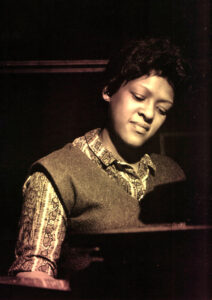 Sepia photo of Shirley Scott playing the piano.