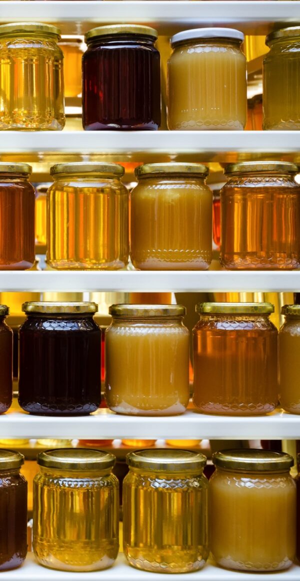 Shelves of jars of honey.